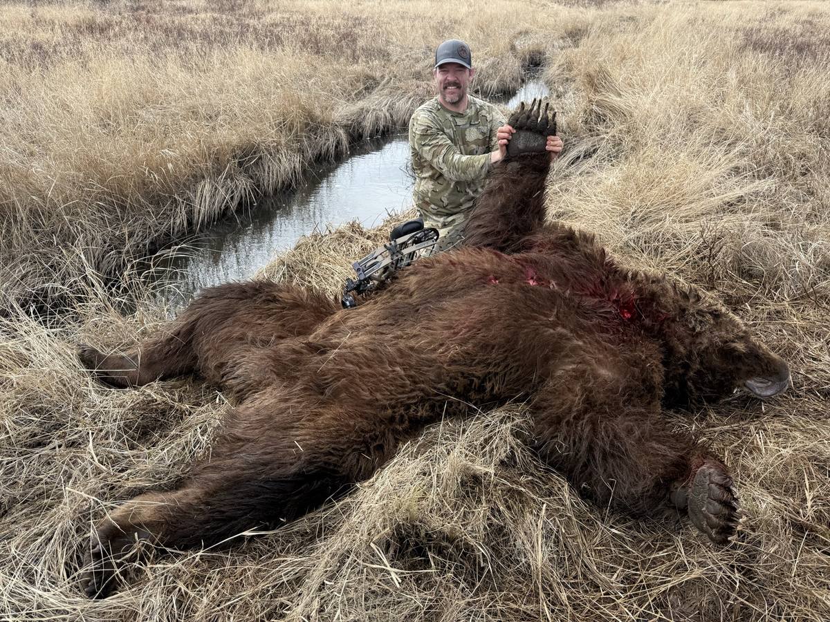 Broc Brimhall with a brown bear taken with a bow on Kodiak Island, Alaska